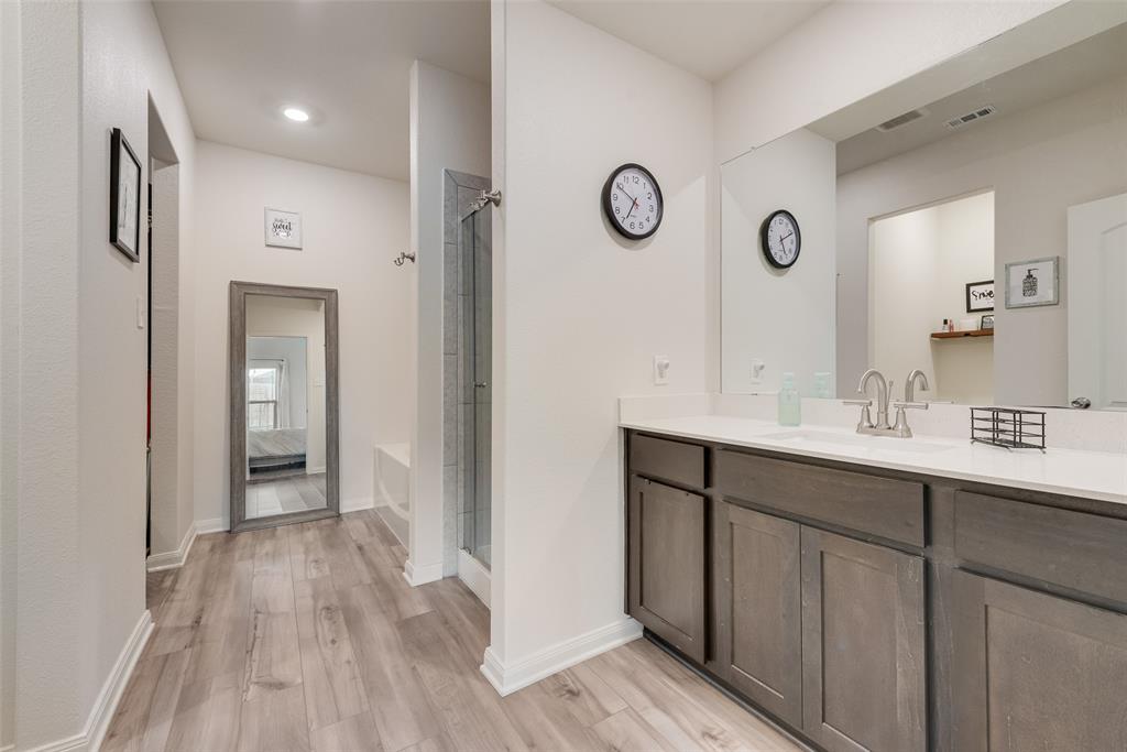 159 Bush Drive Venus, TX 76084 - Photo 2 of 24 a bathroom with a sink and a mirror