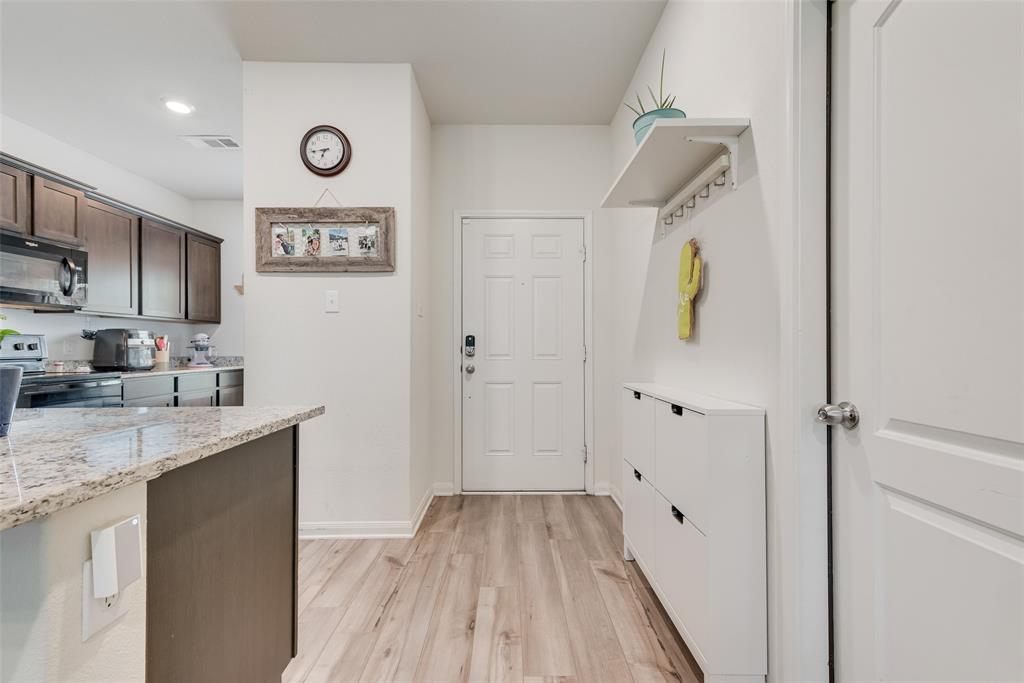 159 Bush Drive Venus, TX 76084 - Photo 4 of 24 a view of a kitchen with a sink and a refrigerator