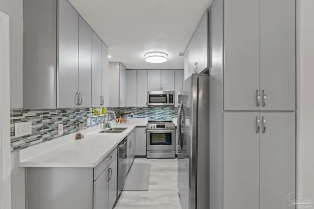 a kitchen with a sink and a refrigerator