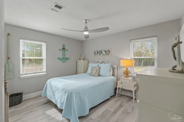 a view of a patio with table and chairs next to a yard