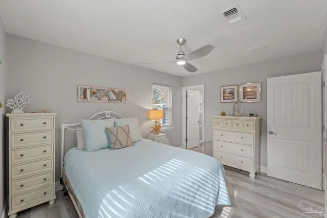 a view of a yard in front of a house with a large tree