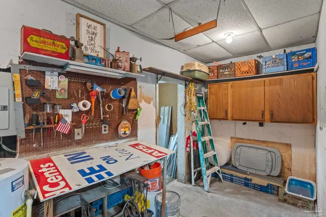 an aerial view of a house with a yard and a large tree