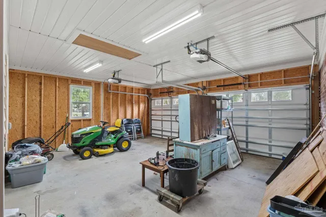 an aerial view of a house with a yard basket ball court and outdoor seating