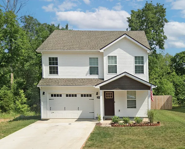a front view of a house with a yard