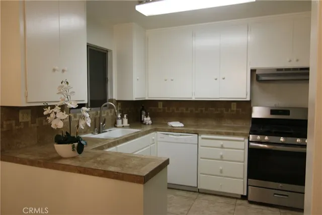 a bathroom with a granite countertop sink toilet and mirror