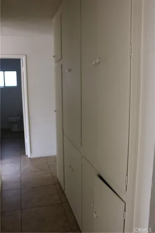 an empty room with wooden floor and sliding door