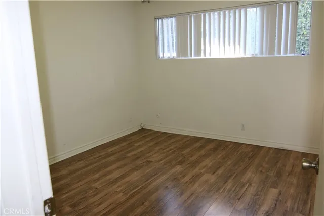 a view of a room with a refrigerator and cabinet