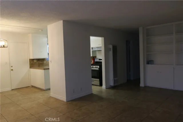 a view of a small space with wooden floor and a window