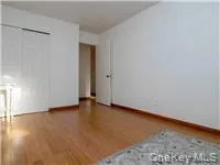 a view of an empty room and wooden floor