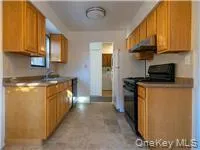a kitchen with stainless steel appliances granite countertop a refrigerator a stove top oven a sink and dishwasher