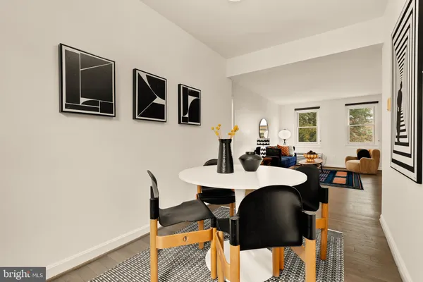 a view of a dining room with furniture and wooden floor