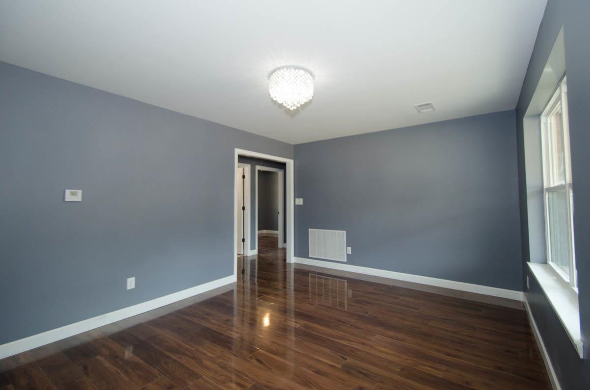 12 East Emory Road Memphis, TN 38109 - Photo 2 of 19 wooden floor in an empty room with a window