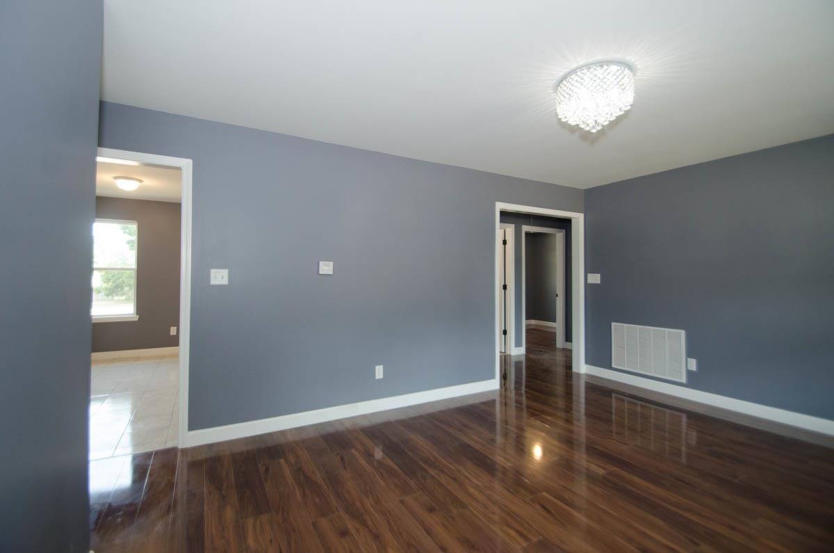 12 East Emory Road Memphis, TN 38109 - Photo 3 of 19 an empty room with wooden floor and windows