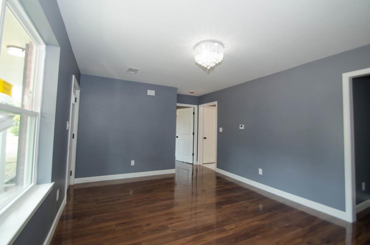 12 East Emory Road Memphis, TN 38109 - Photo 4 of 19 a view of an empty room with wooden floor and a window