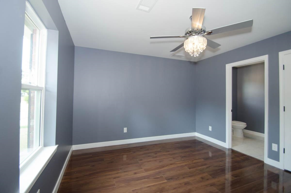 12 East Emory Road Memphis, TN 38109 - Photo 6 of 19 a view of an empty room with wooden floor and a window