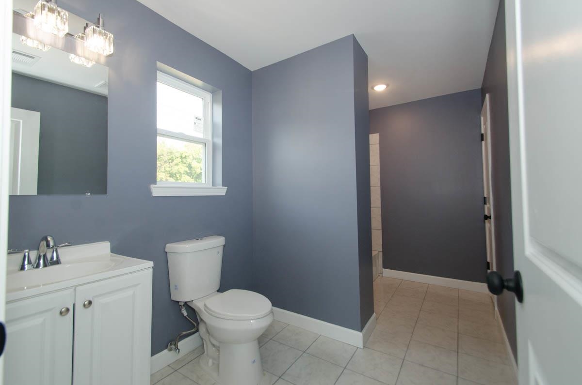 12 East Emory Road Memphis, TN 38109 - Photo 7 of 19 a bathroom with a toilet sink and mirror