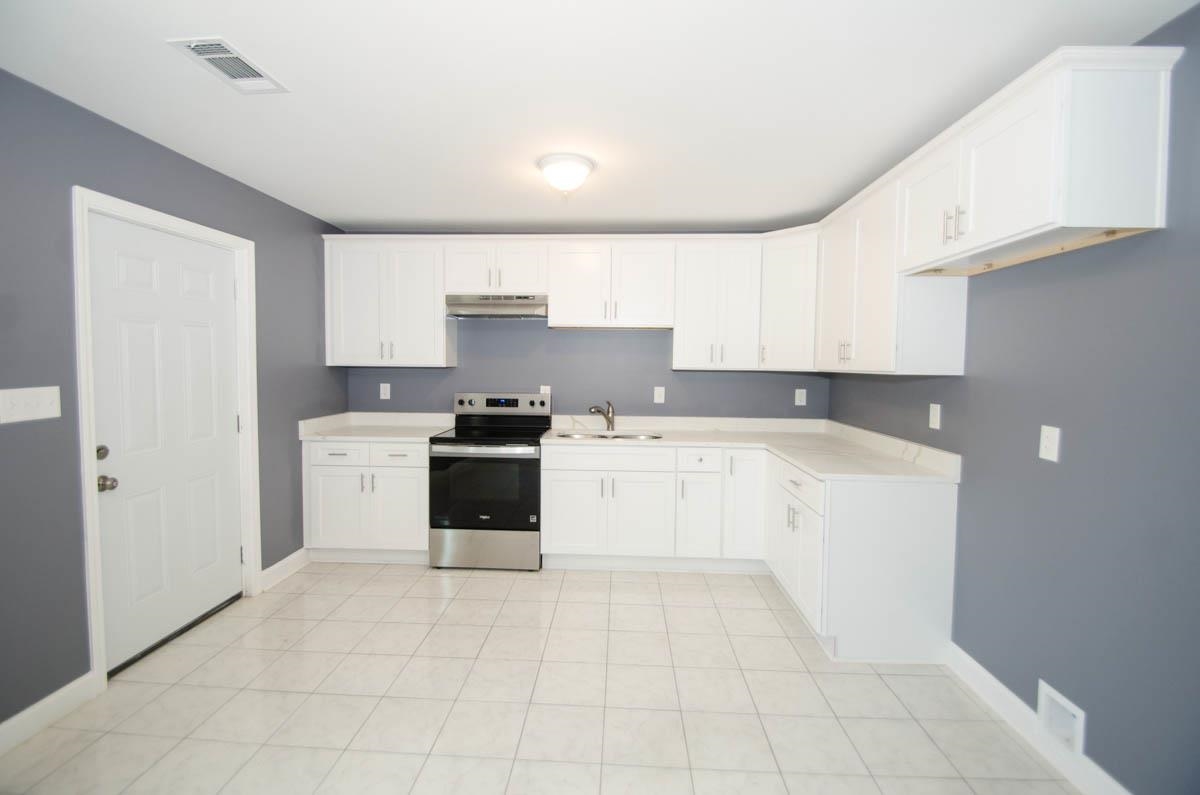 12 East Emory Road Memphis, TN 38109 - Photo 10 of 19 a kitchen with granite countertop white cabinets and white appliances
