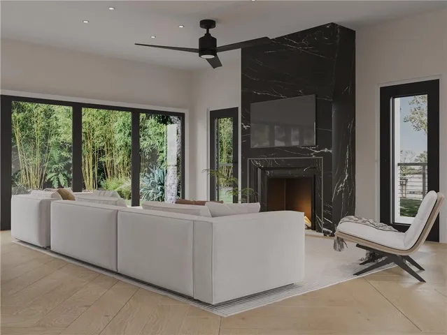 a living room with furniture tv and a large window