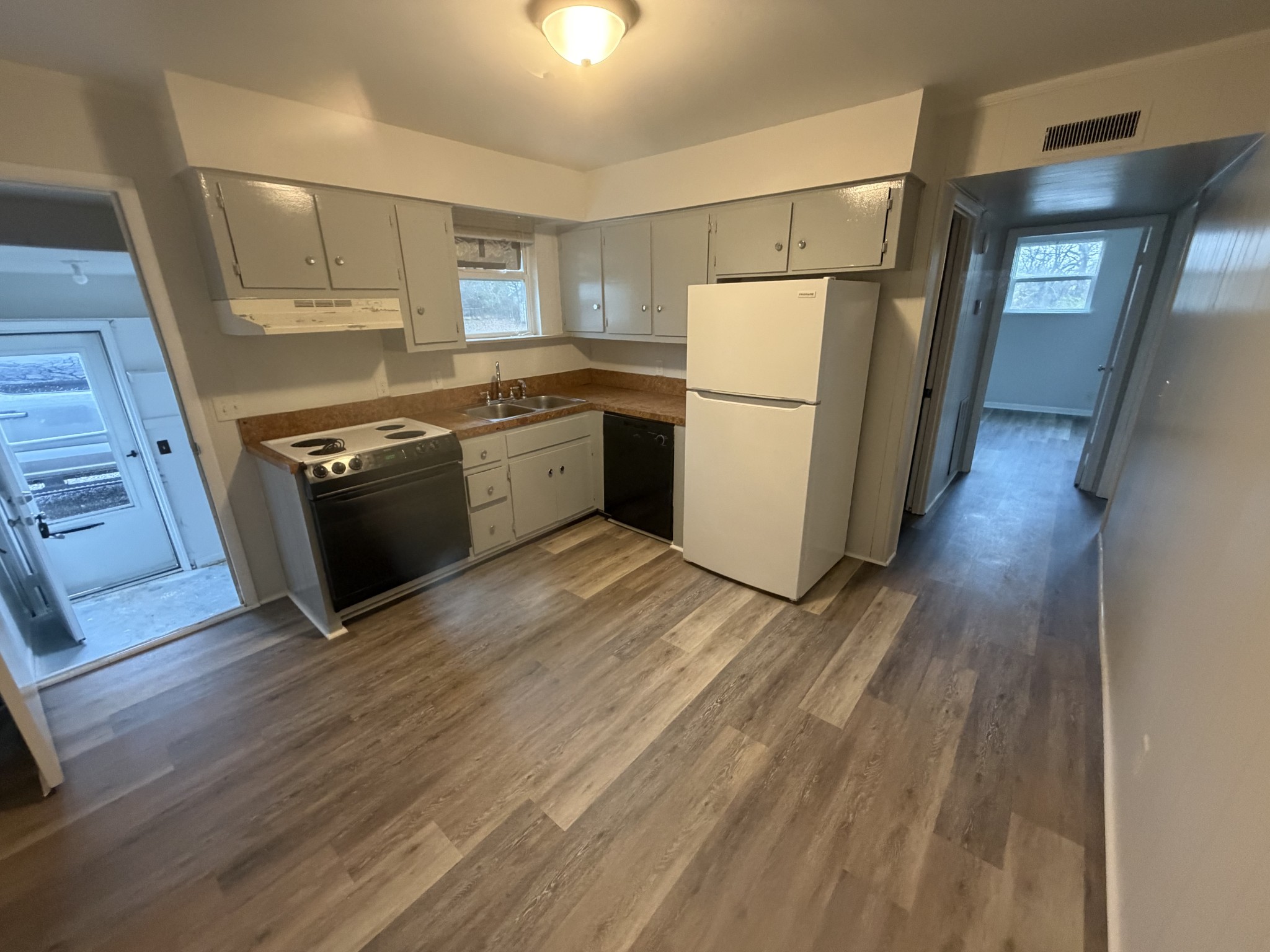 1001 Pierce Road Madison, TN 37115 - Photo 6 of 8 a kitchen with a refrigerator a stove top oven and wooden floor