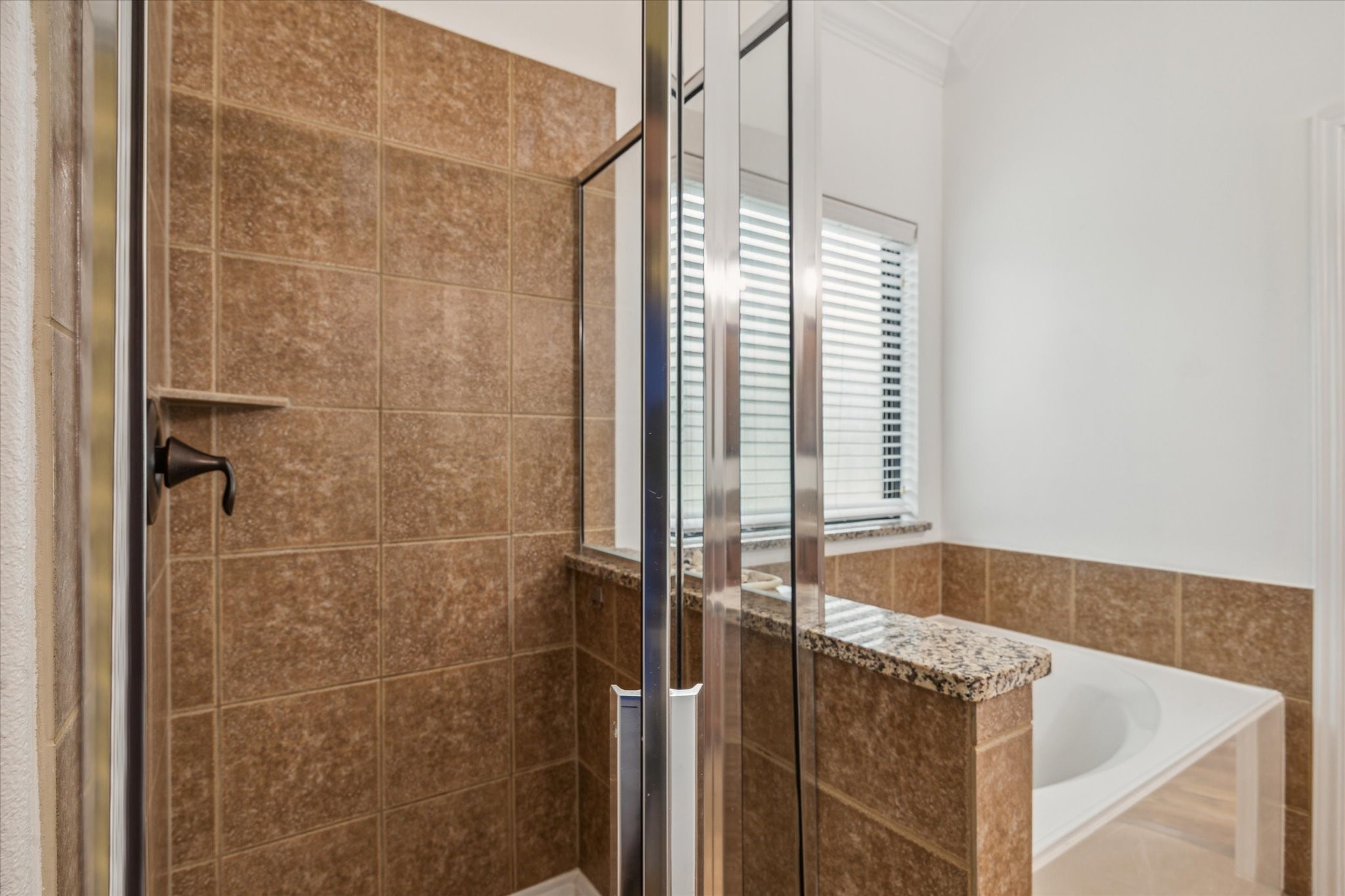 31 Butternut Grove Place Tomball, TX 77375 - Photo 11 of 25 a bathroom with a tub and shower