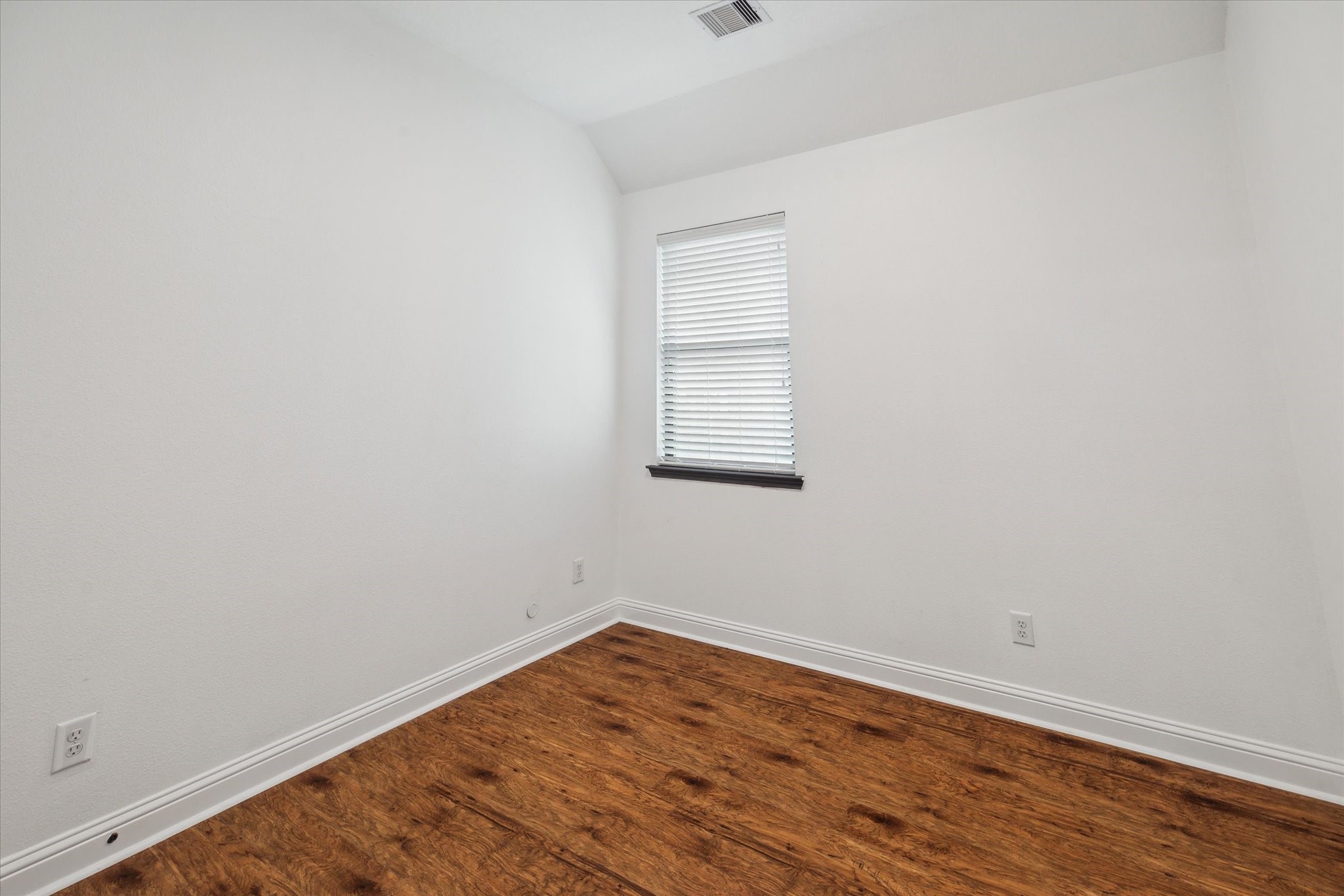 31 Butternut Grove Place Tomball, TX 77375 - Photo 18 of 25 an empty room with wooden floor and windows