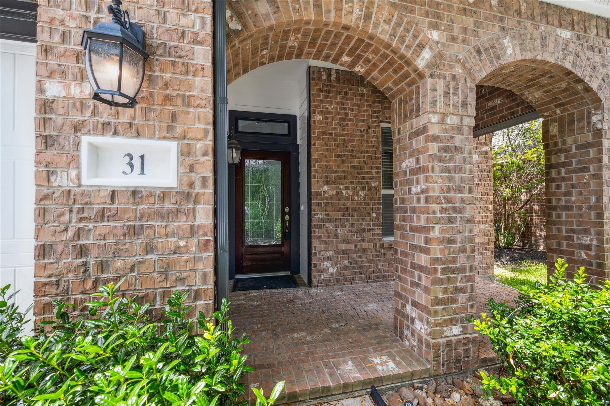31 Butternut Grove Place Tomball, TX 77375 - Photo 2 of 25 a brick building with a black door
