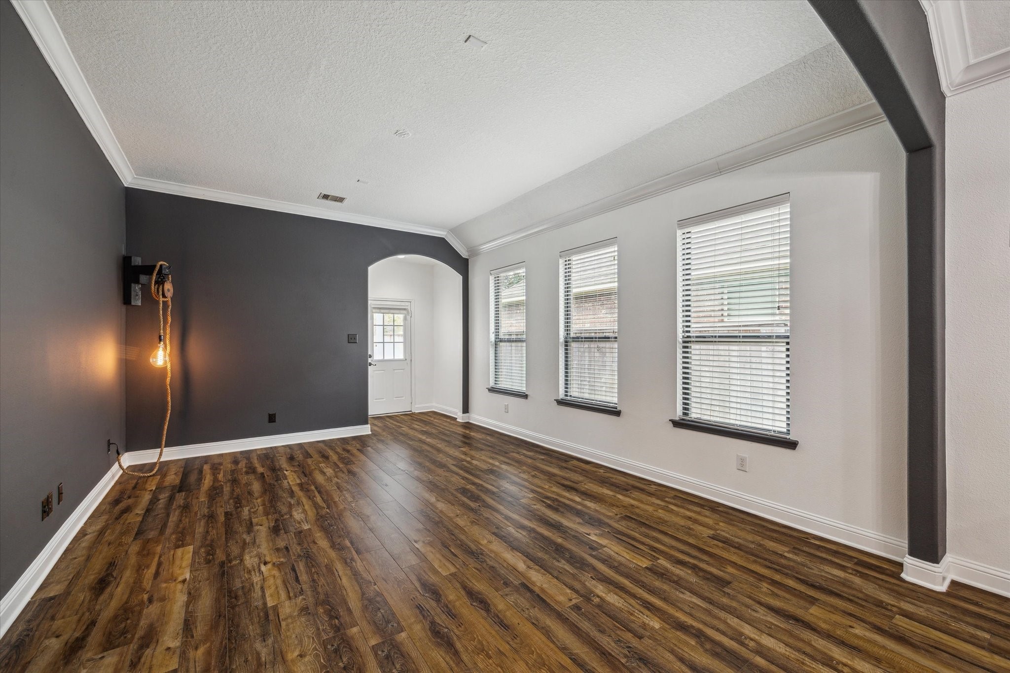 31 Butternut Grove Place Tomball, TX 77375 - Photo 7 of 25 a view of an empty room with wooden floor and a window