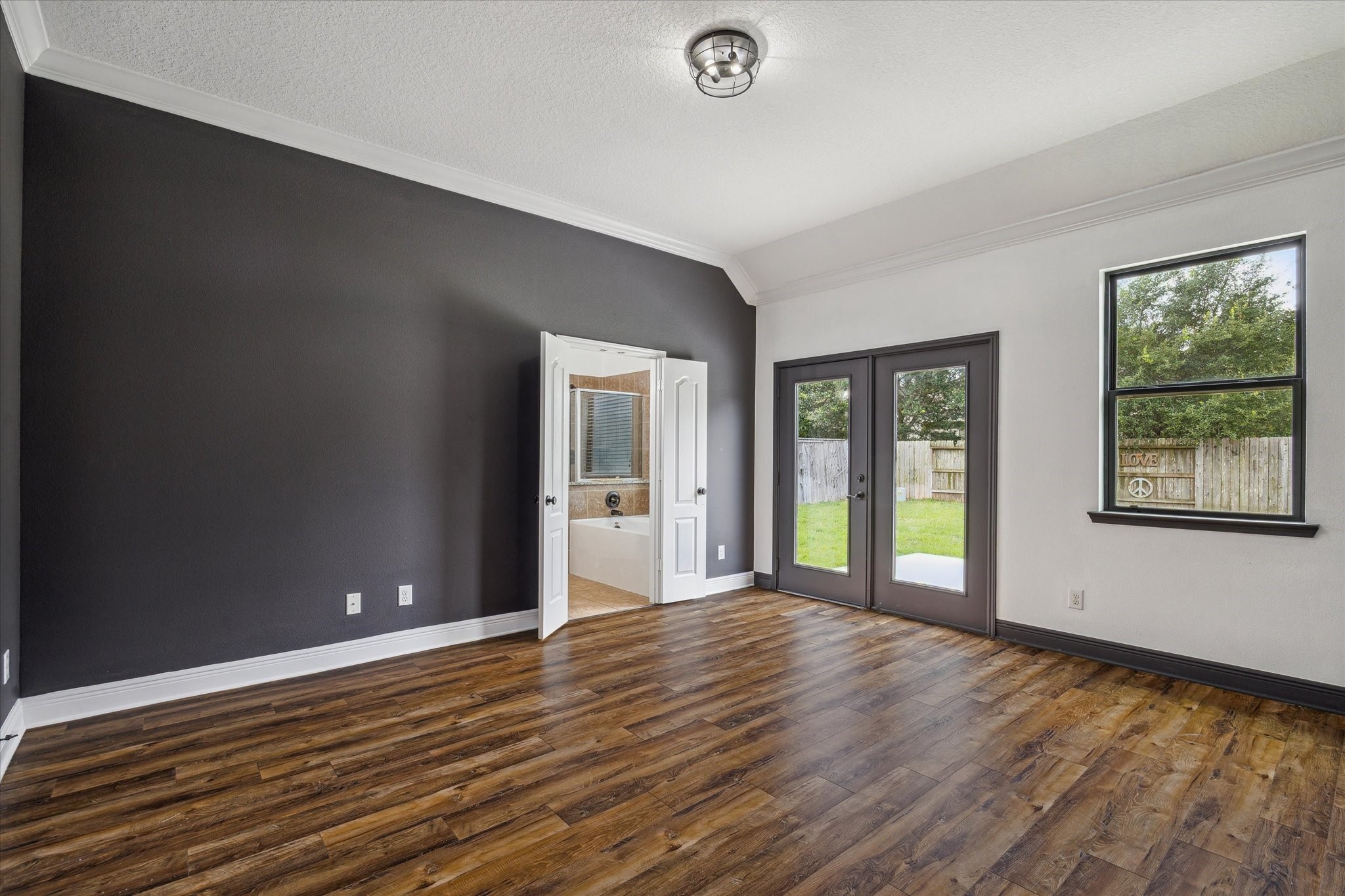 31 Butternut Grove Place Tomball, TX 77375 - Photo 9 of 25 a view of an empty room with window and wooden floor