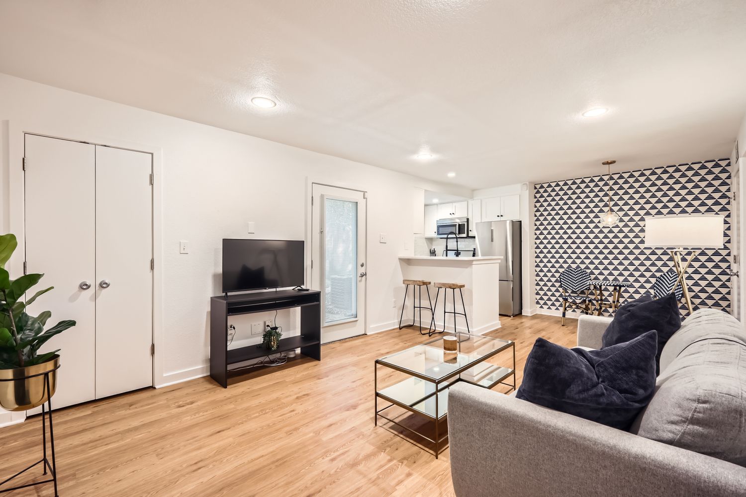 An open concept living area boasts a kitchen with an inviting breakfast bar.