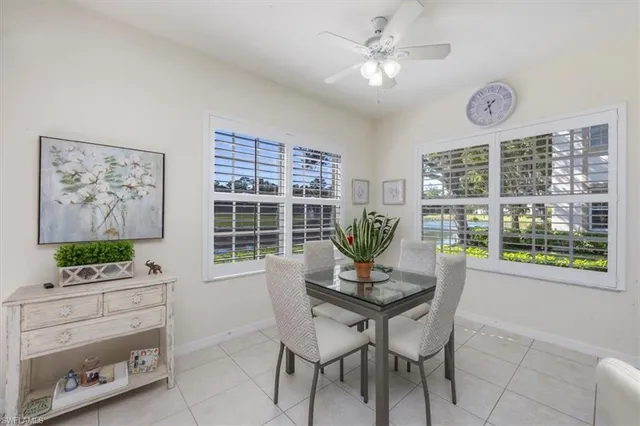 a dining room with furniture a rug and a window
