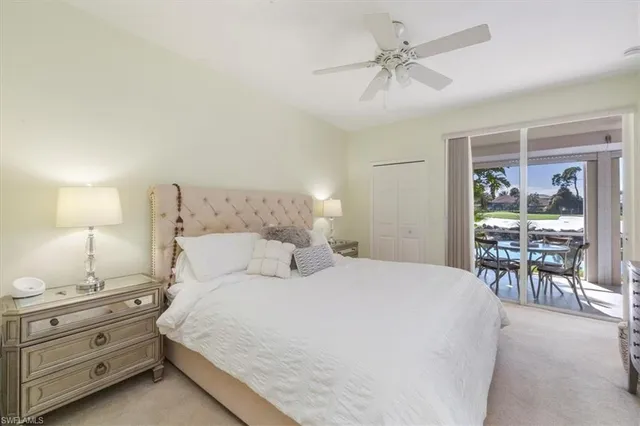 a bedroom with a bed and a table with lamp