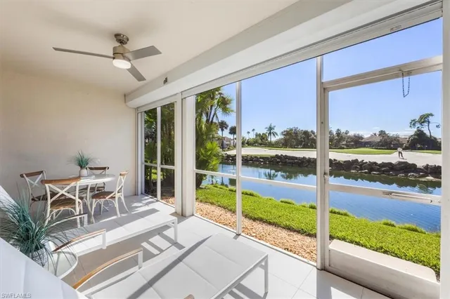 a view of a patio with a table chairs and a floor to ceiling window