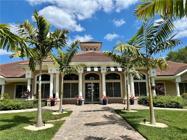 a view of a living room with a floor to ceiling window and wooden floor