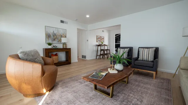 a living room with furniture and a potted plant