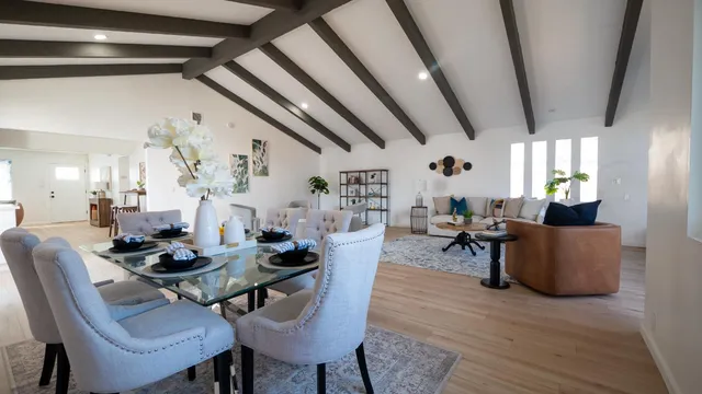 a dining room with furniture and wooden floor