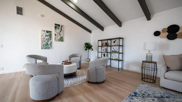 a living room with furniture and a book shelf