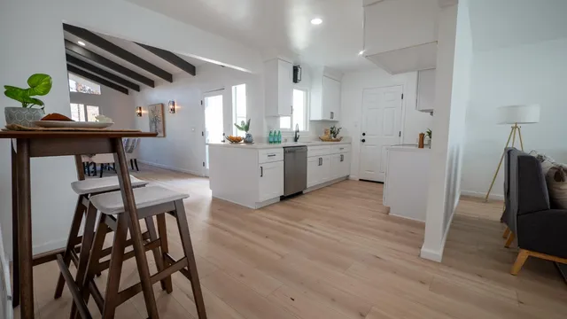 a kitchen with sink cabinets and wooden floor