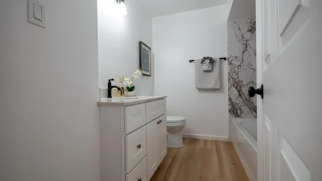 a bathroom with a sink toilet and shower
