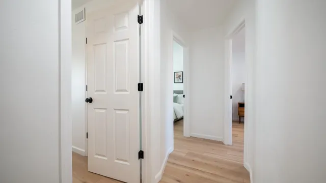 a view of a hallway with wooden floor