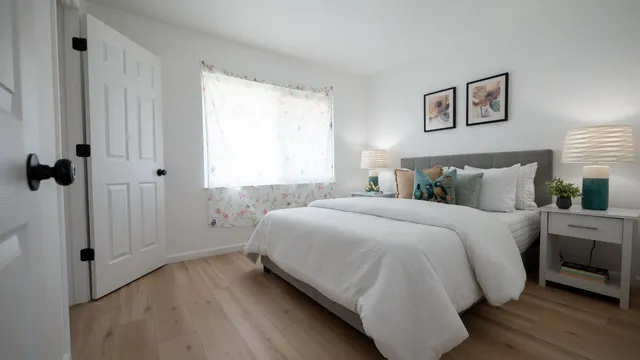 a bedroom with a bed and a window