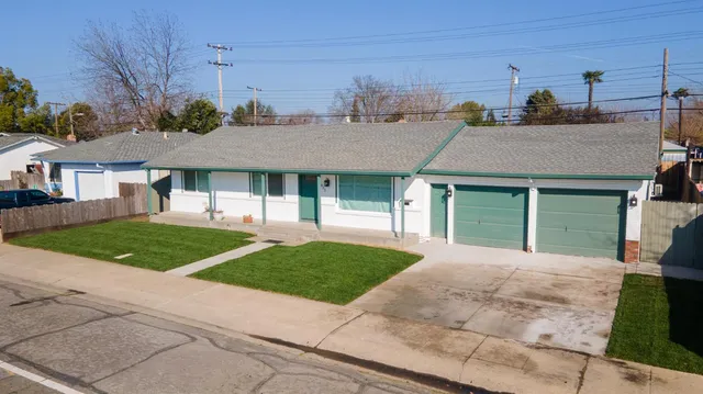a aerial view of a house next to a yard