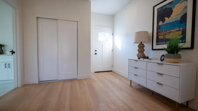 a view of a room that has a bed and a mirror in it