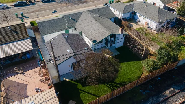 an aerial view of a house with a yard basket ball court and outdoor seating