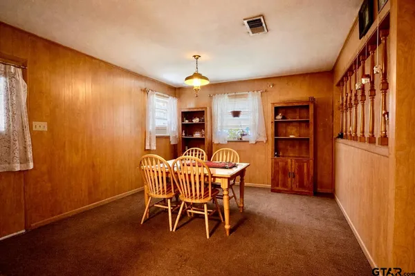 a dining room with furniture and window
