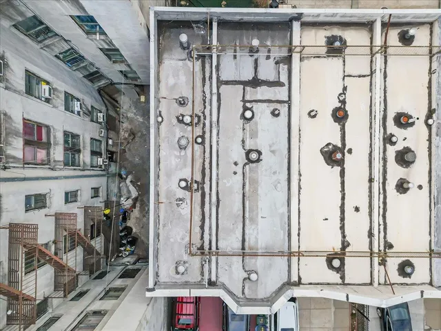 an aerial view of a residential apartment building with glass windows