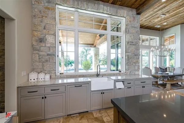a bedroom with a bed a couch and potted plant on the dresser