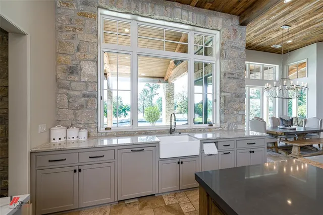 a bedroom with a bed a couch and potted plant on the dresser
