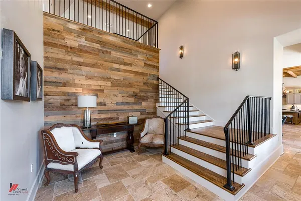 a view of a patio with a table chairs and a floor to ceiling window