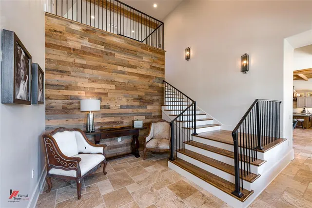 a view of a patio with a table chairs and a floor to ceiling window