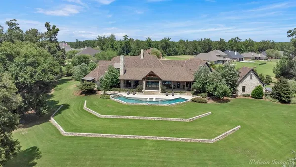 a view of a house with swimming pool and a yard